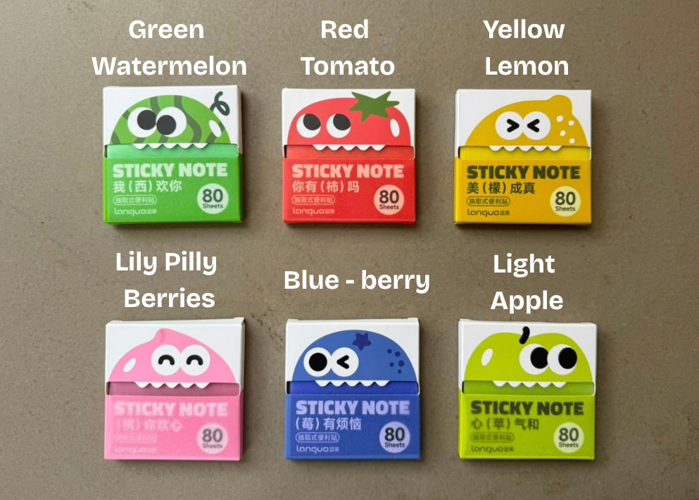 Six boxes of sticky notes in different fruit flavors arranged in a 2x3 grid on a textured gray background. The flavors are labeled in English text above each box: Green Watermelon, Red Tomato, Yellow Lemon, Lily Pilly Berries, Blue-berry, and Light Apple.